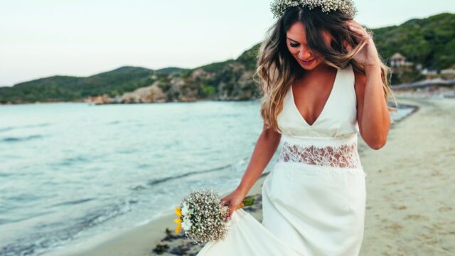 Photo of  bride walking on the beach